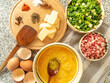 ingredients for preparing omelet with bacon cheese and fresh vegetables