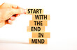© Dzmitry - Start in end of mind symbol. Concept words Start with the end in mind on wooden blocks. Beautiful white table white background. Businessman hand. Business start in end of mind concept. Copy space.