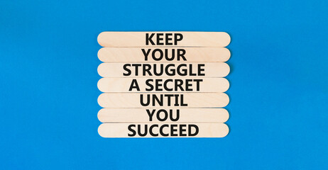 Keep secret symbol. Concept words Keep your struggle a secret until you succeed on wooden stick. Beautiful blue table blue background. Copy space. Motivational business keep secret concept.