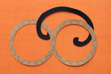 brown infinity symbol and black decor curve on orange