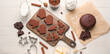 Board with tasty Christmas chocolate cookies, dough and ingredients on white wooden background