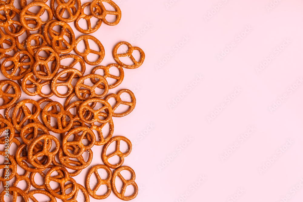 Tasty pretzels on pink background