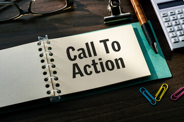 Poster - There is a notebook with the word Call To Action. It is eye-catching image.