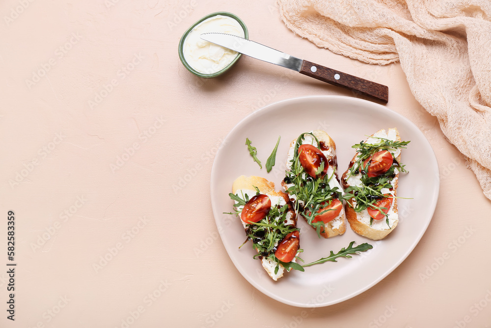 Plate with tasty sandwiches and cutter on color background