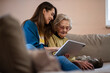 © Studio Dva Kera - Nurse and senior woman reviewing medical records on a digital tablet.