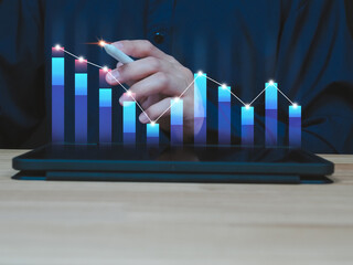 man showing business analysis financial investment Analyze financial graphs on a virtual screen via tablet.