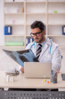 © Elnur - Young male doctor radiologist working in the clinic