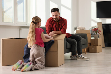 Sticker - Family settling into home. Happy father and daughter unpacking boxes in new apartment. Moving day