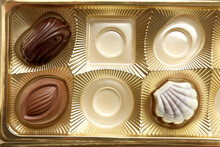 Partially Empty Box Of Chocolate Candies As Background, Top View