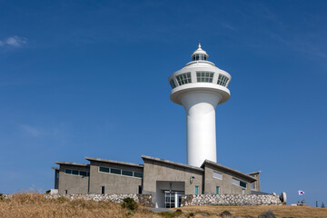 Wall Mural - white lighthouse and blue sky