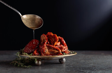 Sun-dried tomatoes with thyme in olive oil.