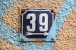 © varbenov - Weathered grunge square metal enameled plate of number of street address with number 39
