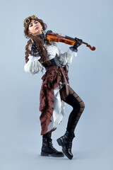 Country girl with violin on the grey background.