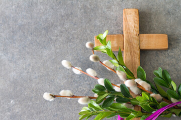 wooden cross and easter palm tree made of catkins and boxwood, palm sunday concept