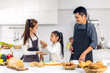 © Art_Photo - Portrait of enjoy happy love asian family father and mother with little asian girl daughter child play and having fun cooking food together with baking cookie and cake ingredient in kitchen