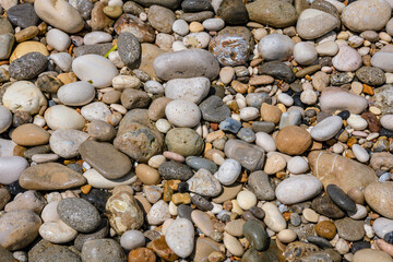 Wall Mural - Pebbles on a Ionian coast in Agios Gordios resort village on Corfu Island, Greece