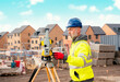 © Iryna - Surveyor builder site engineer with theodolite total station at construction site outdoors during surveying work