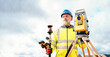 © Iryna - Surveyor builder site engineer with theodolite total station at construction site outdoors during surveying work
