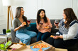 © AntonioDiaz - Happy female friends talking and eating pizza together
