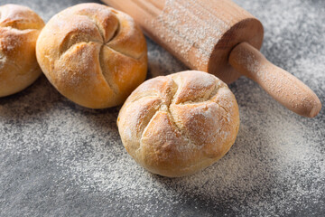 Aufkleber - Set of small bun bread on the dark table with rolling pin. Fresh home baking concept