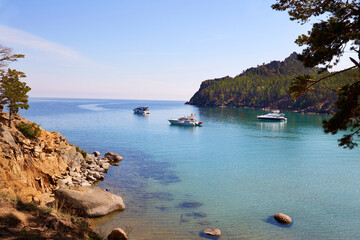 Wall Mural - Picturesque summer landscape. Yachts in a bay with turquoise water color. Coniferous forest. Holidays on the seashore.