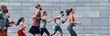 © gstockstudio - Group of young people in sports clothing running outdoors together