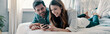 © gstockstudio - Beautiful young couple looking at smart phone and smiling while spending time in bed at home