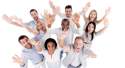 Canvas Print - Top view studio shot of excited people in smart casual wear looking up and stretching out hands