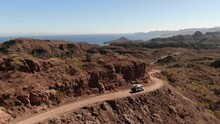 Aerial Of Camper Driving On Shelf Dirt Road To Small Town Of Agua Verde In Baja California Sur Along Sea Of Cortez Coastline