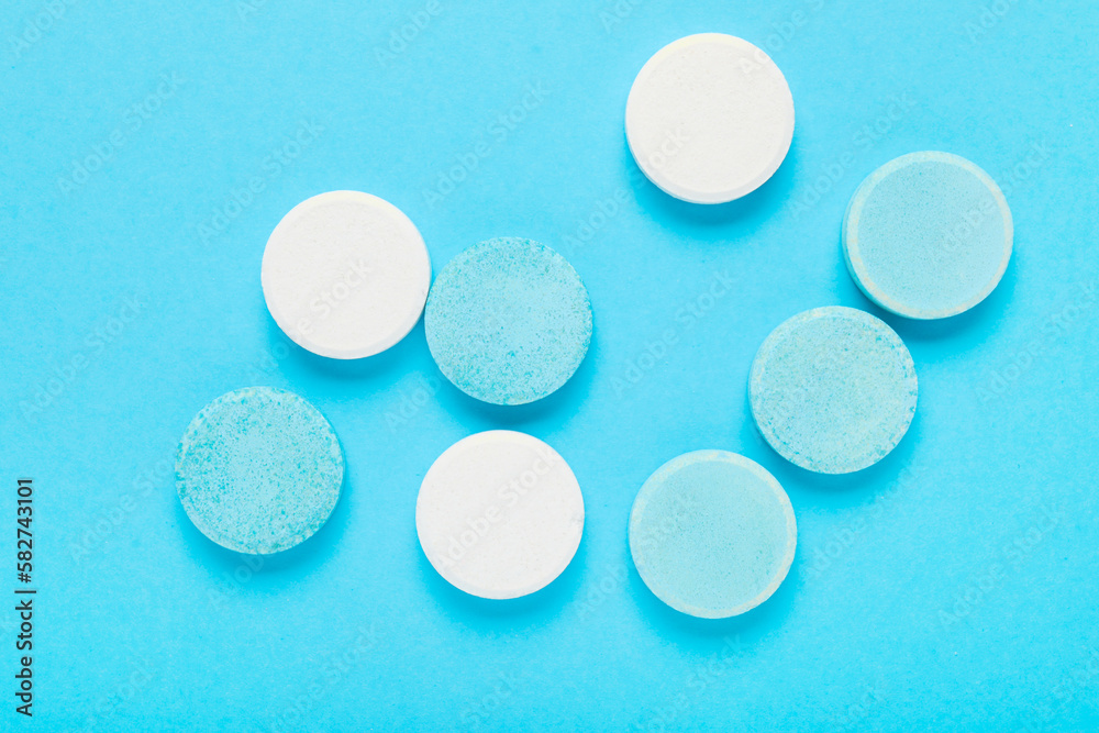 Soluble tablets on blue background