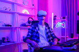 Fototapeta  - Young Caucasian man Pro Gamer have live streaming  playing video game,  using virtual reality glasses at home