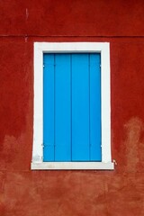 Blue window of red building in Venice