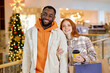 © Roman - diverse happy beautiful elegant stylish young couple holding shopping bags, smiling while standing in mall, family, rest, close up portrait