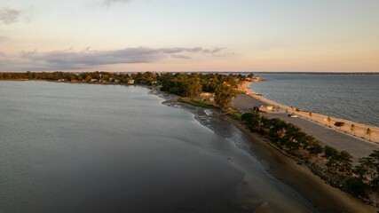 Sticker - Aerial view of a golden sunrise on the gold coast of Long Island, New York, over an empty beach.