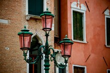 Close-up Shot Of Street Lamps With Colorful Buildings In Background, Venice, Italy