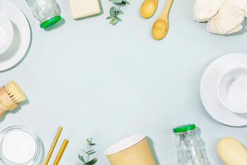 Sustainable kitchen cleaning concept. Eco friendly still life with dishes, cups, bamboo brushes, natural cleaning products and accessories. No plastic, zero waste flat lay. Top view, copy space