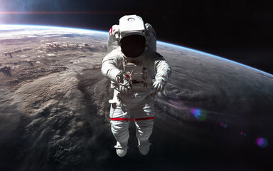 Wall Mural - astronaut in orbit of planet earth. solar system. science fiction. elements of this image furnished 