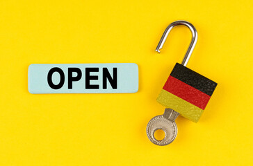 Poster - On the yellow surface is an open lock with a key and a sticker with the inscription - open