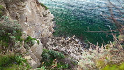 Wall Mural - Collapse of stones on a rocky seashore.