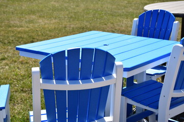 Canvas Print - Blue and White Lawn Chairs by a Table