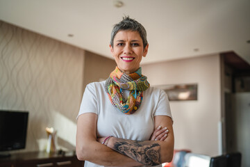 Portrait of one mature senior woman stand alone in apartment at home