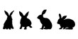 Królik - czarna sylwetka na białym tle. Cztery różne króliki. Siedzący zając. Ilustracja wektorowa do projektów.