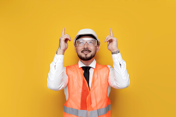 Wall Mural - male asian foreman in uniform shows hands up on mine space, korean construction engineer in hardhat and goggles