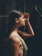 © SHOTPRIME STUDIO - Sexy woman, body in a swimsuit takes a tropical shower outdoors against the backdrop of green tropical leaves, flowers and palm trees. Body and hair care, tanned skin, sunlight, smile, vintage