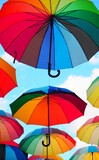 Fototapeta Tęcza - Rainbow umbrella floating in the sky
