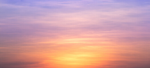 Wall Mural - Real amazing panoramic sunrise or sunset sky with gentle colorful clouds. Long panorama, crop it. Evening sky scene with golden light from the setting sun