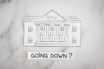 Wall Mural - insolvency and banks closing down concept, bank made of paper with Going Down ? caption underneat