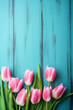 © Aquir - Tulip border with copy space. Bouquet of pink tulips flowers on turquoise blue vintage wooden background. generative ai. Beautiful frame composition of spring flowers