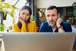 © Westend61 - Focused business colleagues watching laptop at loft office