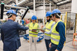 © Westend61 - Engineer shaking hand with colleague standing in robotics factory
